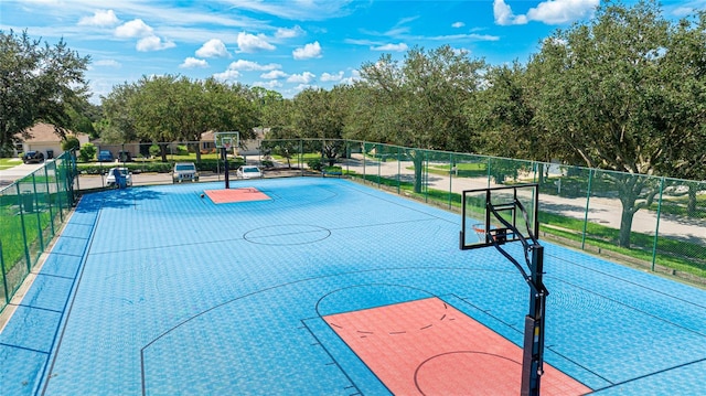 view of basketball court featuring fence and community basketball court