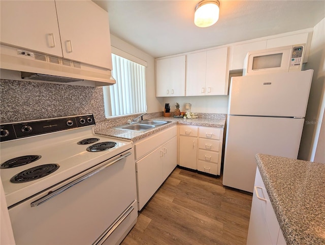 5895 17th St W Unit B-26, Bradenton, FL 34207 - kitchen with white appliances, a sink, under cabinet range hood, wood finished floors, and light countertops