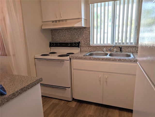 5895 17th St W Unit B-26, Bradenton, FL 34207 - kitchen with white appliances, under cabinet range hood, a sink, and white cabinetry