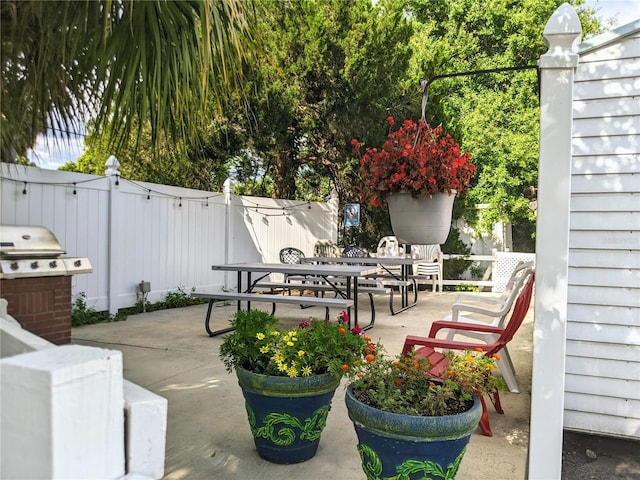 5895 17th St W Unit B-26, Bradenton, FL 34207 - view of patio / terrace with outdoor dining space, a fenced backyard, and grilling area