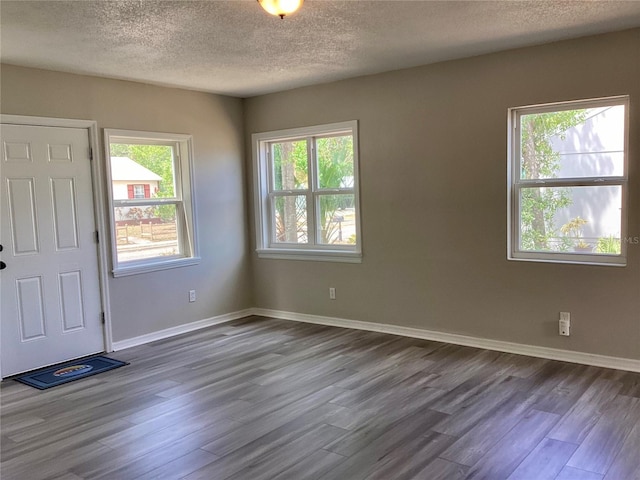 entryway featuring dark wood-type flooring, a textured ceiling, and baseboards