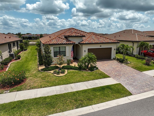 20542 Trattoria Loop, Venice, FL 34293 - mediterranean / spanish-style home with a garage, decorative driveway, stucco siding, a front yard, and central AC unit