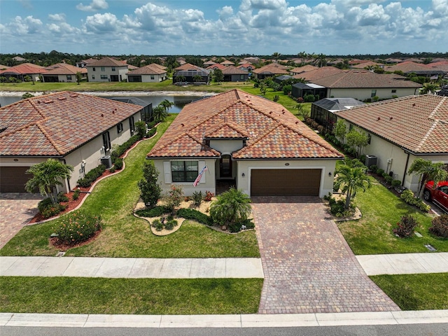 20542 Trattoria Loop, Venice, FL 34293 - mediterranean / spanish-style home featuring a residential view, a garage, driveway, a tiled roof, and stucco siding