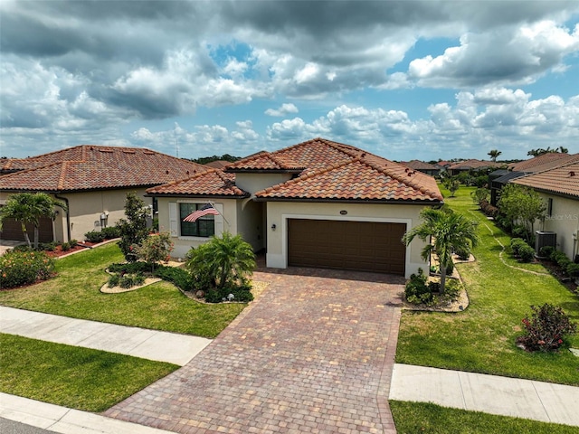 20542 Trattoria Loop, Venice, FL 34293 - mediterranean / spanish house with an attached garage, decorative driveway, stucco siding, and a front lawn