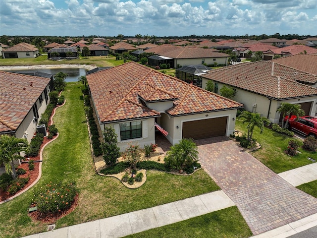 20542 Trattoria Loop, Venice, FL 34293 - mediterranean / spanish-style house with a garage, a residential view, decorative driveway, a tiled roof, and stucco siding