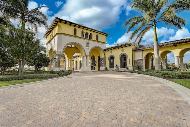 20542 Trattoria Loop, Venice, FL 34293 - mediterranean / spanish house with curved driveway, stucco siding, and a tile roof