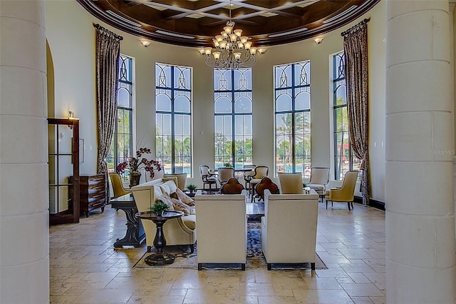 20542 Trattoria Loop, Venice, FL 34293 - dining area featuring a towering ceiling, stone tile flooring, coffered ceiling, a chandelier, and crown molding