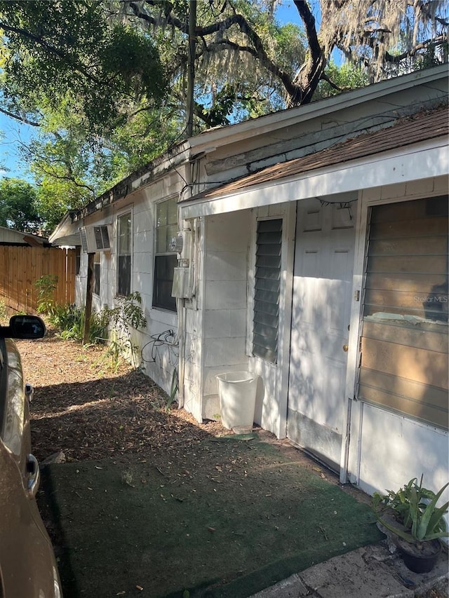 view of side of property featuring fence