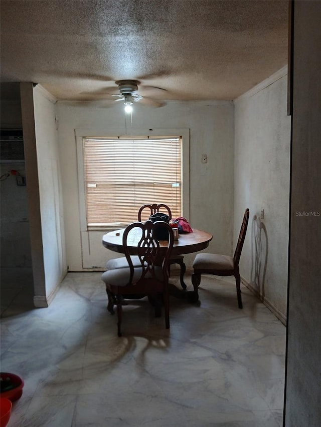 dining area with a ceiling fan and a textured ceiling