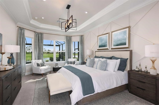 carpeted bedroom with a chandelier, a tray ceiling, and ornamental molding