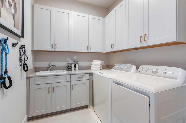 laundry area with washer and clothes dryer and cabinet space