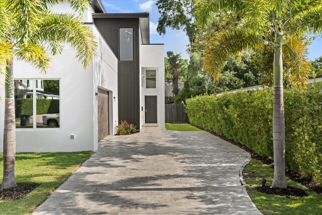 1521 Chestnut Ave, Winter Park, FL 32789 - view of home's exterior featuring driveway, a garage, fence, and stucco siding