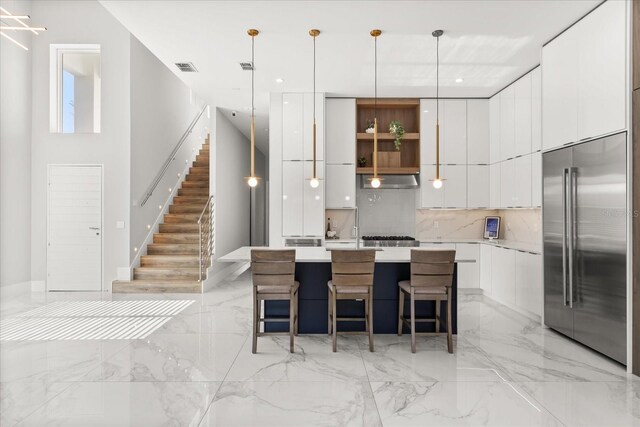 1521 Chestnut Ave, Winter Park, FL 32789 - kitchen with modern cabinets, stainless steel built in refrigerator, backsplash, white cabinets, and light marble finish floors