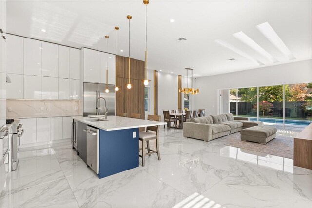 1521 Chestnut Ave, Winter Park, FL 32789 - kitchen with modern cabinets, high end appliances, light marble finish floors, and open floor plan