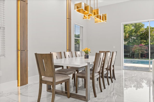 1521 Chestnut Ave, Winter Park, FL 32789 - dining room featuring light marble finish floors, plenty of natural light, and a towering ceiling