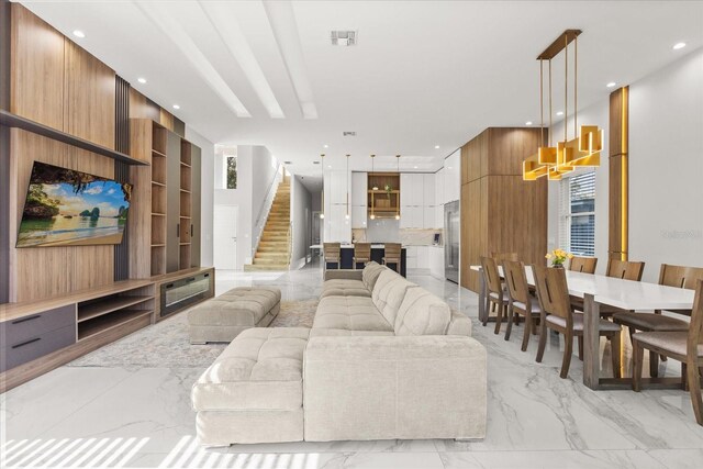 1521 Chestnut Ave, Winter Park, FL 32789 - living room featuring light marble finish flooring, stairs, built in shelves, recessed lighting, and plenty of natural light