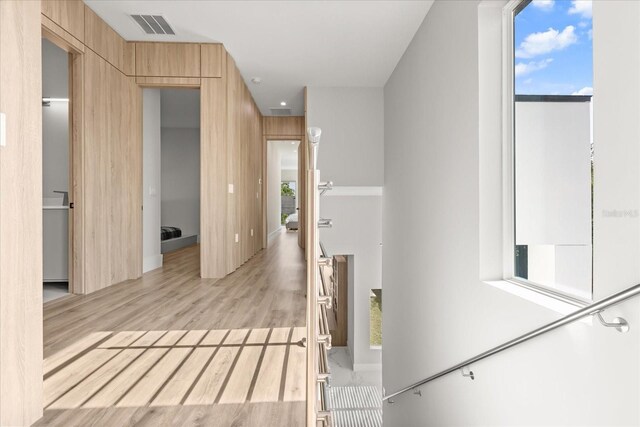 1521 Chestnut Ave, Winter Park, FL 32789 - corridor featuring healthy amount of natural light, light wood-style flooring, and wooden walls