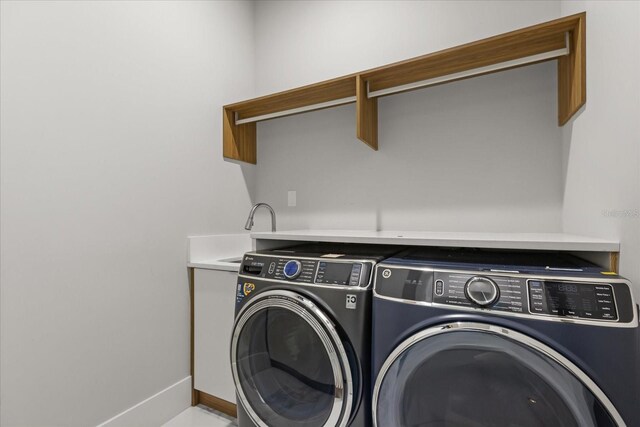 1521 Chestnut Ave, Winter Park, FL 32789 - clothes washing area with washer and dryer, cabinet space, and baseboards