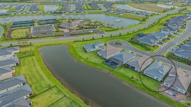 aerial view of residential area featuring a nearby body of water