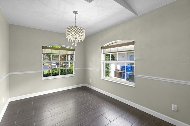 3263 Woodberry Ln Lot 15, Sarasota, FL 34231 - empty room with baseboards, plenty of natural light, and a chandelier