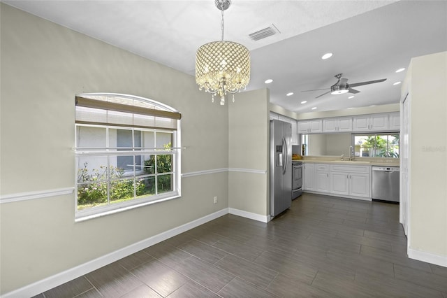 3263 Woodberry Ln Lot 15, Sarasota, FL 34231 - kitchen featuring stainless steel appliances, baseboards, a sink, a chandelier, and white cabinets