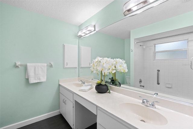 3263 Woodberry Ln Lot 15, Sarasota, FL 34231 - full bathroom featuring double vanity, baseboards, a textured ceiling, toilet, and shower / bathtub combination