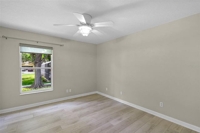 3263 Woodberry Ln Lot 15, Sarasota, FL 34231 - unfurnished room featuring light wood finished floors, a ceiling fan, baseboards, and a textured ceiling