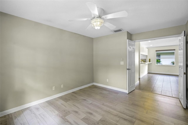 3263 Woodberry Ln Lot 15, Sarasota, FL 34231 - empty room with wood finished floors, a ceiling fan, and baseboards