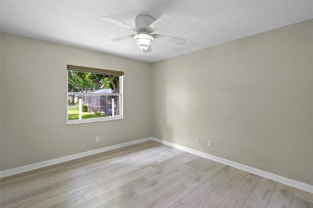 3263 Woodberry Ln Lot 15, Sarasota, FL 34231 - spare room featuring a ceiling fan, light wood-type flooring, a textured ceiling, and baseboards