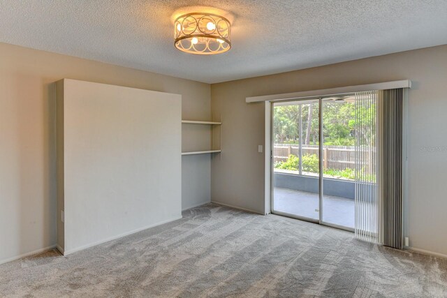7719 9th Avenue Dr NW, Bradenton, FL 34209 - spare room with carpet floors, a textured ceiling, and a chandelier