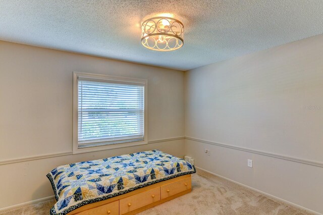 7719 9th Avenue Dr NW, Bradenton, FL 34209 - bedroom with carpet flooring, a textured ceiling, and baseboards