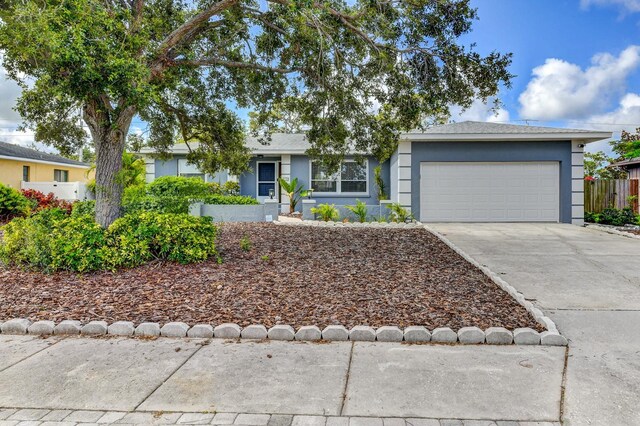 7719 9th Avenue Dr NW, Bradenton, FL 34209 - ranch-style house with stucco siding, concrete driveway, and a garage