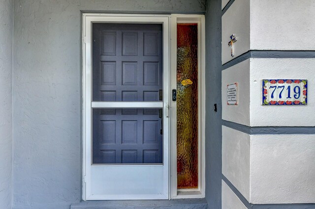 7719 9th Avenue Dr NW, Bradenton, FL 34209 - property entrance featuring stucco siding