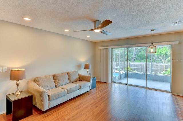 7719 9th Avenue Dr NW, Bradenton, FL 34209 - living area with ceiling fan, plenty of natural light, a textured ceiling, light wood-type flooring, and recessed lighting
