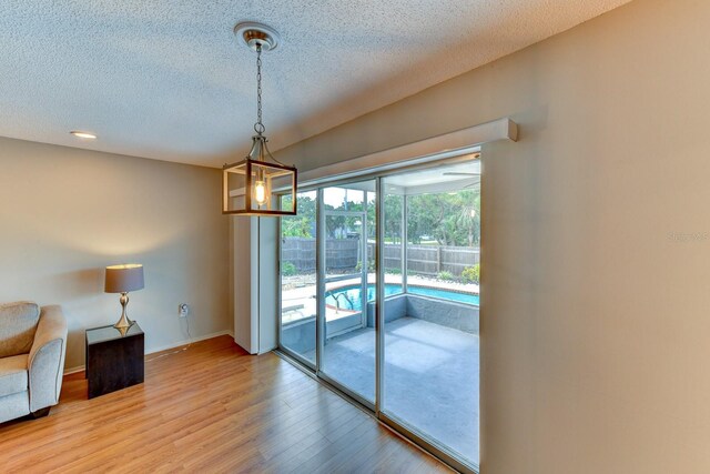 7719 9th Avenue Dr NW, Bradenton, FL 34209 - unfurnished room with a textured ceiling, light wood finished floors, and baseboards