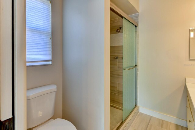 7719 9th Avenue Dr NW, Bradenton, FL 34209 - bathroom featuring vanity, toilet, a shower stall, and baseboards