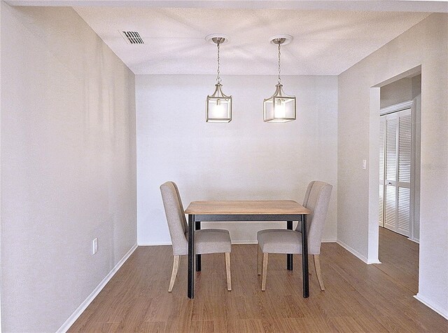 7719 9th Avenue Dr NW, Bradenton, FL 34209 - dining space with wood finished floors and baseboards