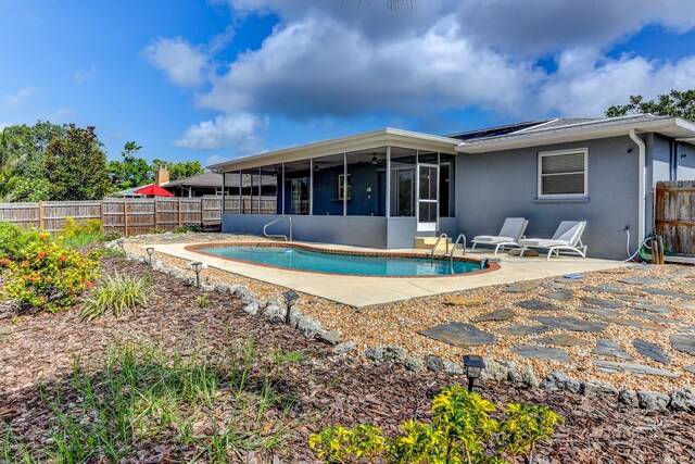 7719 9th Avenue Dr NW, Bradenton, FL 34209 - rear view of house featuring a sunroom, a fenced backyard, stucco siding, and a patio area