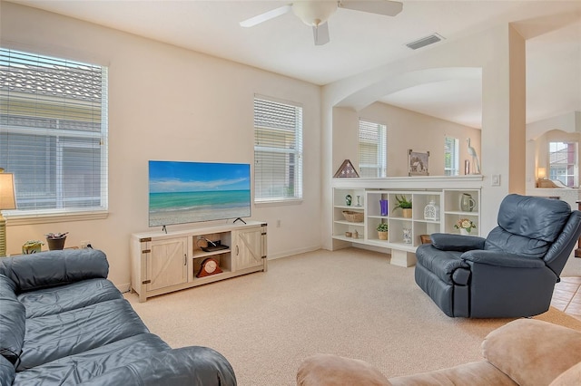 4322 Reflections Pkwy, Sarasota, FL 34233 - carpeted living room featuring arched walkways, ceiling fan, and baseboards