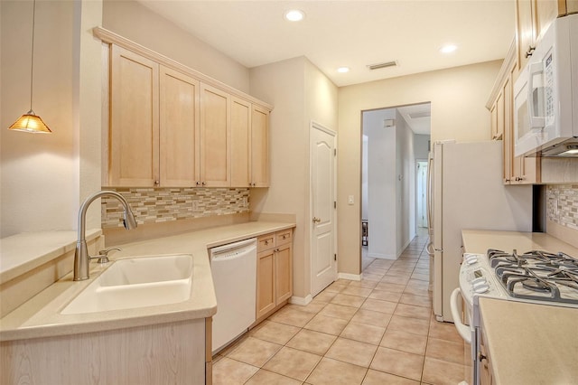4322 Reflections Pkwy, Sarasota, FL 34233 - kitchen featuring white appliances, a sink, light brown cabinets, tasteful backsplash, and recessed lighting