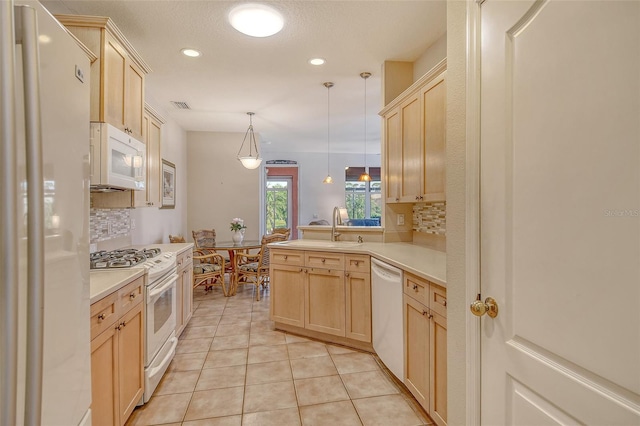 4322 Reflections Pkwy, Sarasota, FL 34233 - kitchen featuring white appliances, light brown cabinetry, decorative backsplash, a sink, and recessed lighting