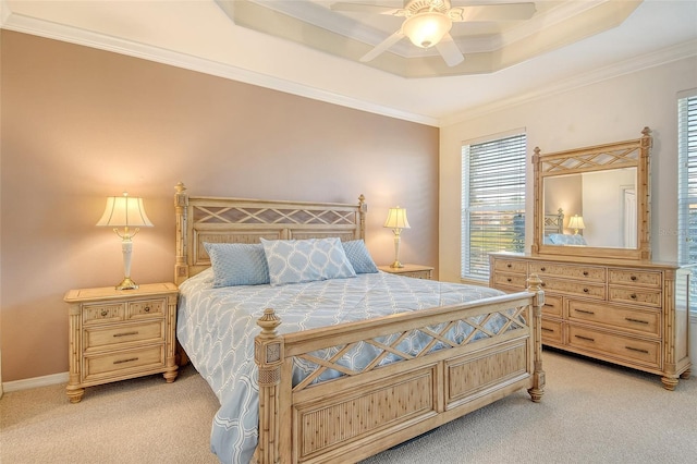 4322 Reflections Pkwy, Sarasota, FL 34233 - bedroom with light colored carpet, crown molding, multiple windows, and a tray ceiling