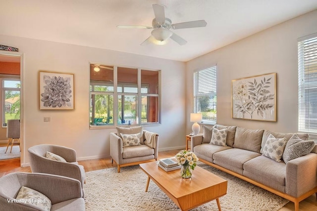4322 Reflections Pkwy, Sarasota, FL 34233 - living room featuring plenty of natural light, light wood finished floors, and a ceiling fan