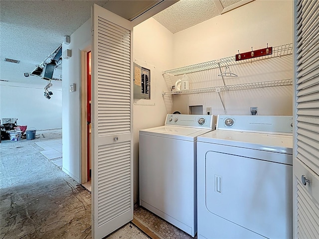 2188 Corinne Ct S Unit A, Saint Petersburg, FL 33712 - laundry area featuring washing machine and dryer, electric panel, and a textured ceiling