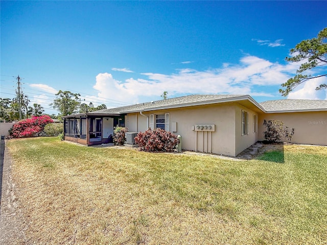 2188 Corinne Ct S Unit A, Saint Petersburg, FL 33712 - back of house featuring a sunroom, stucco siding, and a lawn