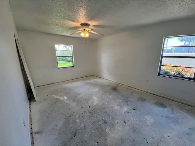 2188 Corinne Ct S Unit A, Saint Petersburg, FL 33712 - empty room featuring a textured ceiling, unfinished concrete flooring, and ceiling fan
