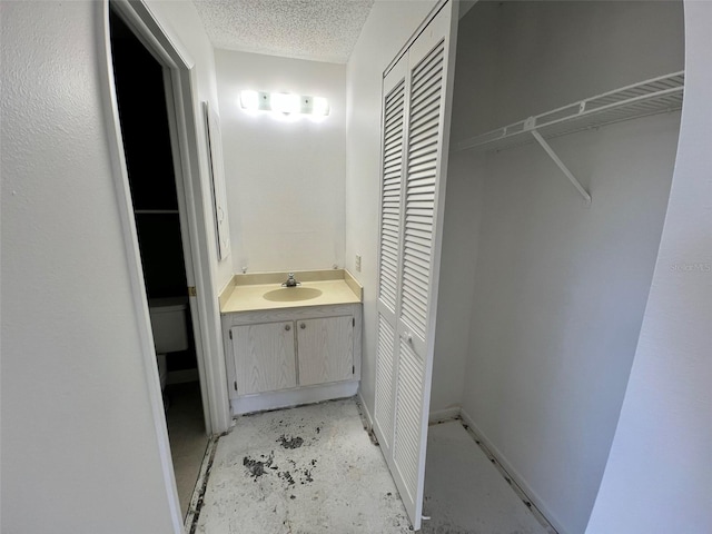 2188 Corinne Ct S Unit A, Saint Petersburg, FL 33712 - bathroom with a closet, vanity, a textured ceiling, and concrete floors