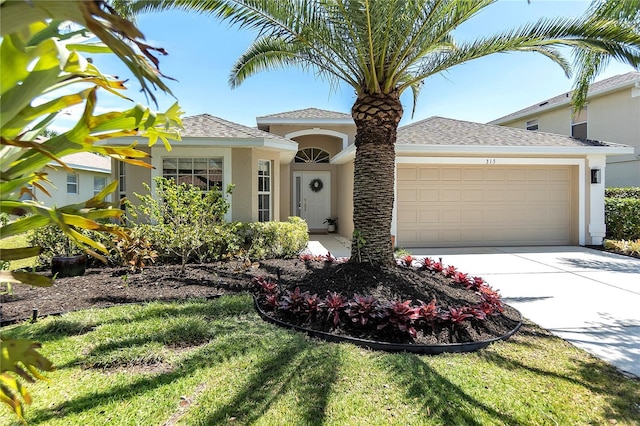 315 Heritage Isles Way, Bradenton, FL 34212 - view of front of house with stucco siding, a garage, driveway, and roof with shingles