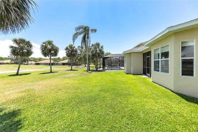 315 Heritage Isles Way, Bradenton, FL 34212 - view of grassy yard featuring glass enclosure