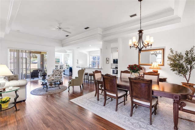 315 Heritage Isles Way, Bradenton, FL 34212 - dining space featuring a tray ceiling, plenty of natural light, wood finished floors, a ceiling fan, and ornamental molding